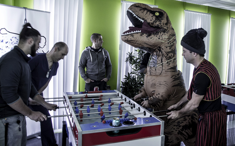 Creaform's employees playing baby foot with a T-Rex